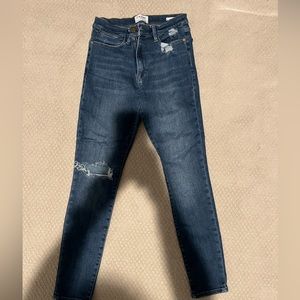 FRAME denim “Le High Skinny” with distressing on one knee.